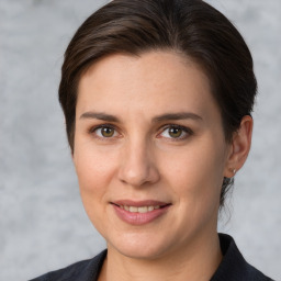 Joyful white young-adult female with medium  brown hair and brown eyes