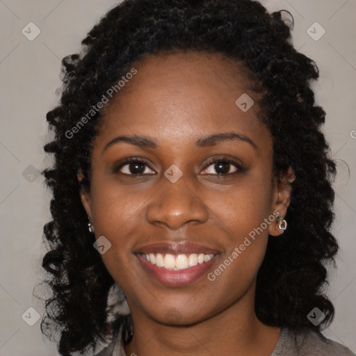 Joyful black young-adult female with long  black hair and brown eyes