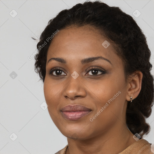 Joyful black young-adult female with medium  black hair and brown eyes