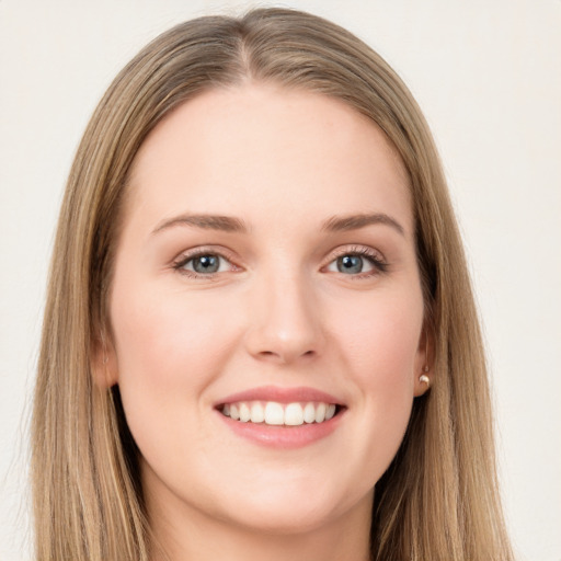 Joyful white young-adult female with long  brown hair and grey eyes