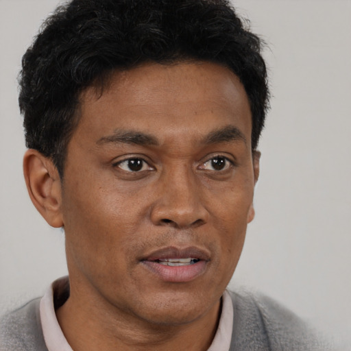 Neutral black adult male with short  brown hair and brown eyes