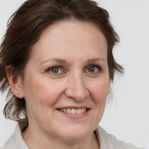 Joyful white adult female with medium  brown hair and grey eyes