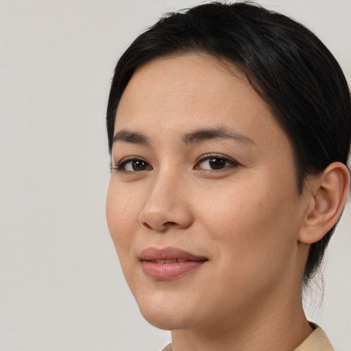Joyful asian young-adult female with medium  brown hair and brown eyes