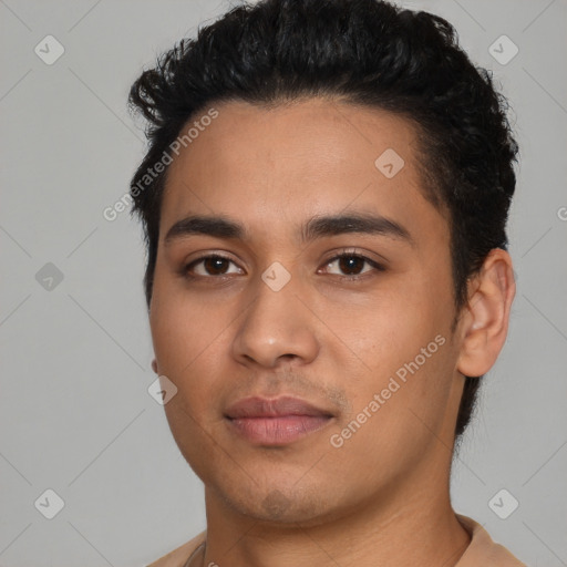 Joyful latino young-adult male with short  black hair and brown eyes