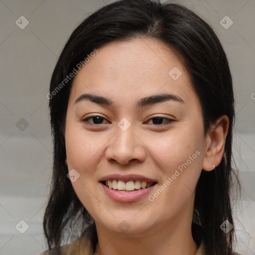 Joyful latino young-adult female with medium  brown hair and brown eyes