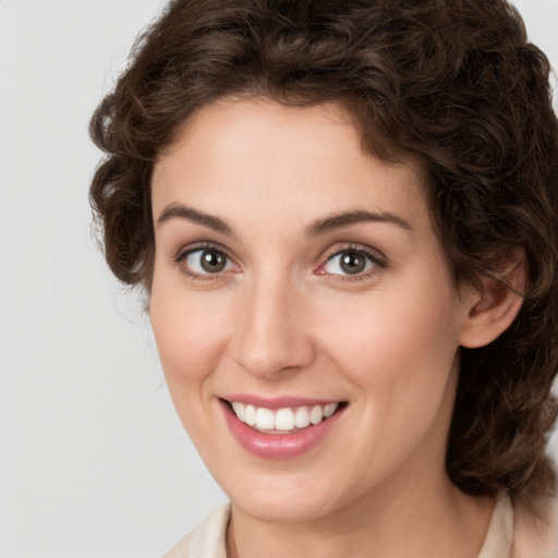 Joyful white young-adult female with medium  brown hair and green eyes