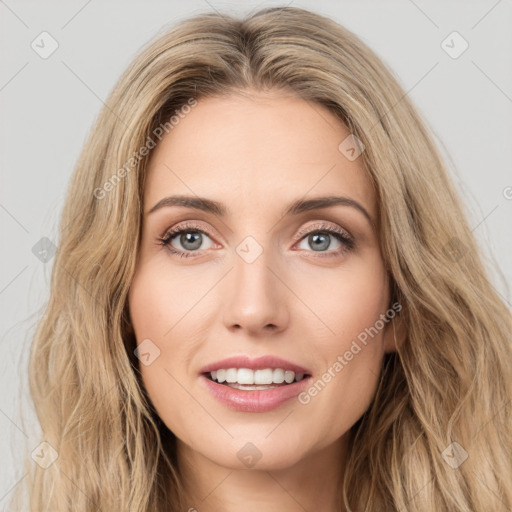 Joyful white young-adult female with long  brown hair and green eyes