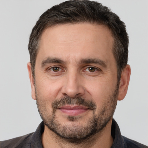 Joyful white adult male with short  brown hair and brown eyes