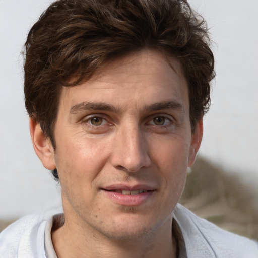 Joyful white adult male with short  brown hair and grey eyes