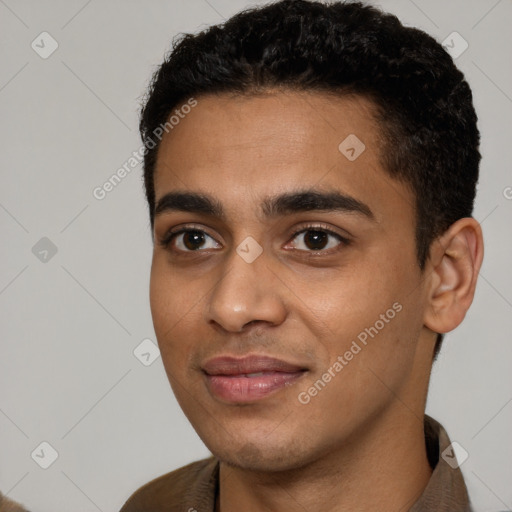 Joyful latino young-adult male with short  black hair and brown eyes