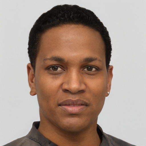 Joyful black young-adult male with short  black hair and brown eyes