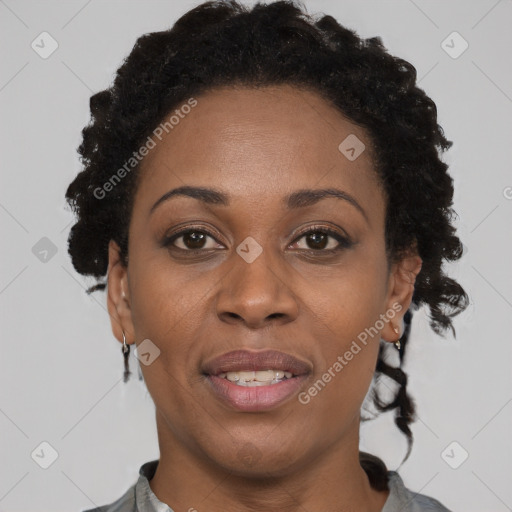 Joyful black adult female with short  brown hair and brown eyes