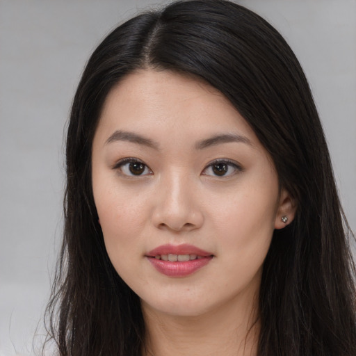 Joyful asian young-adult female with long  brown hair and brown eyes