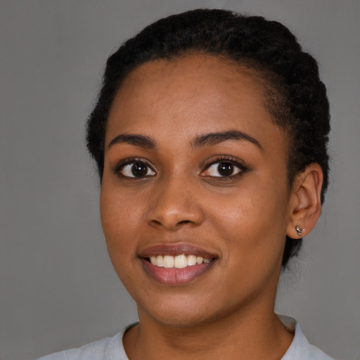 Joyful black young-adult female with short  brown hair and brown eyes