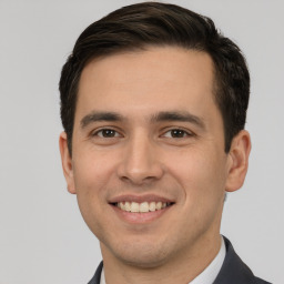 Joyful white young-adult male with short  brown hair and brown eyes