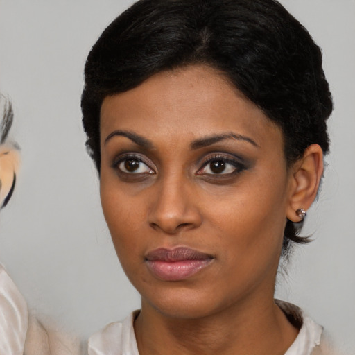 Neutral black young-adult female with medium  brown hair and brown eyes