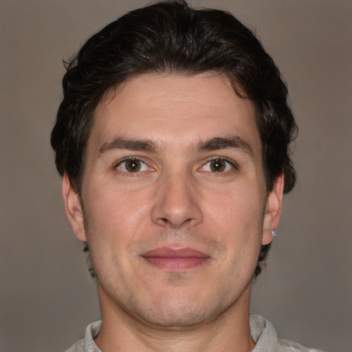 Joyful white adult male with short  brown hair and brown eyes