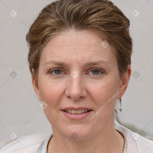 Joyful white adult female with short  brown hair and grey eyes