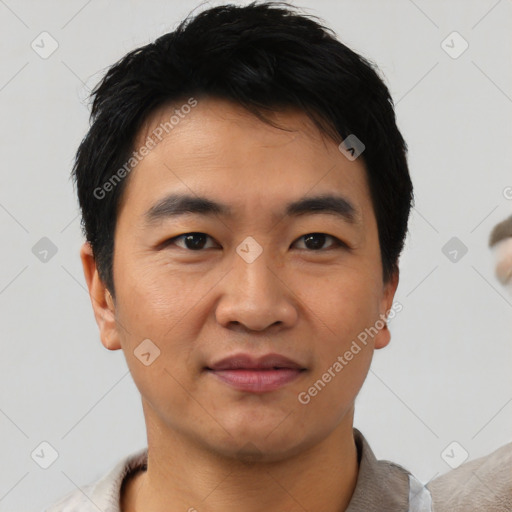 Joyful asian young-adult male with short  black hair and brown eyes