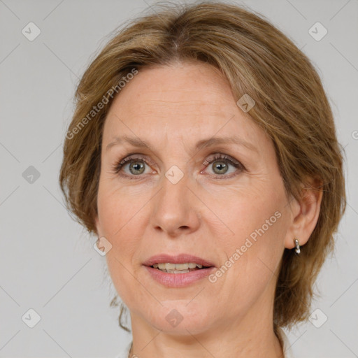 Joyful white adult female with medium  brown hair and green eyes