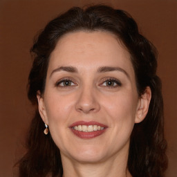 Joyful white adult female with long  brown hair and brown eyes