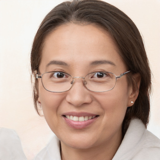 Joyful white adult female with medium  brown hair and brown eyes