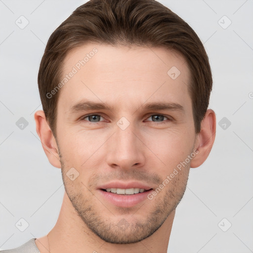 Joyful white young-adult male with short  brown hair and grey eyes