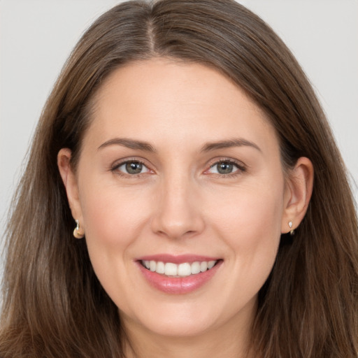 Joyful white young-adult female with long  brown hair and brown eyes