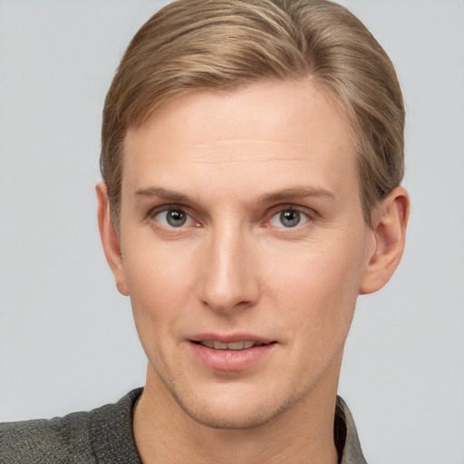 Joyful white young-adult male with short  brown hair and grey eyes