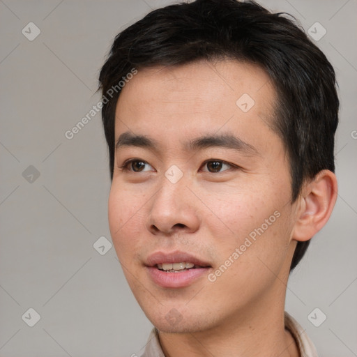 Joyful asian young-adult male with short  black hair and brown eyes