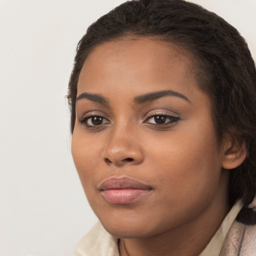 Joyful latino young-adult female with long  brown hair and brown eyes