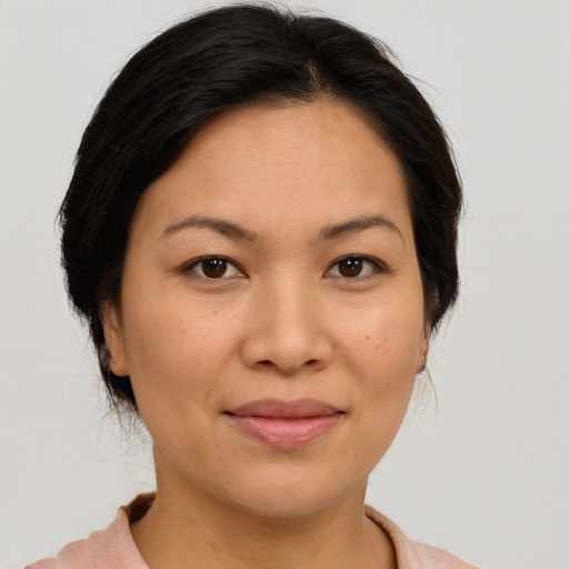 Joyful asian young-adult female with medium  brown hair and brown eyes