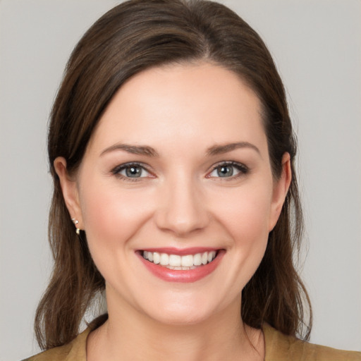 Joyful white young-adult female with medium  brown hair and brown eyes