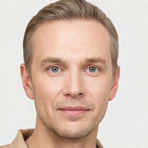 Joyful white adult male with short  brown hair and grey eyes