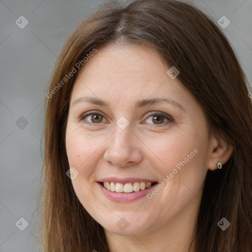 Joyful white adult female with long  brown hair and brown eyes