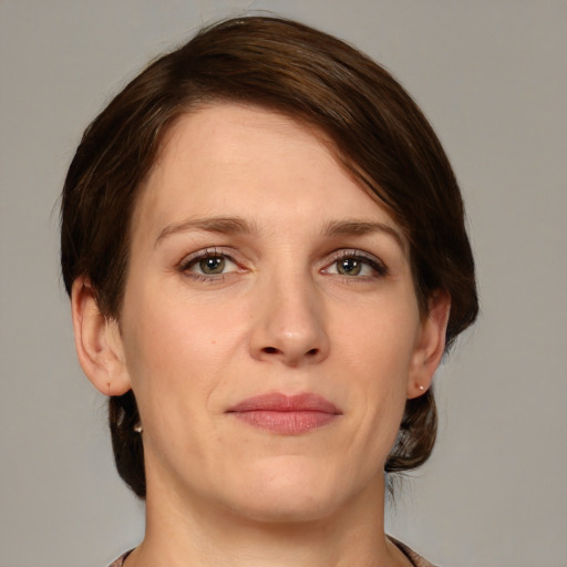 Joyful white young-adult female with medium  brown hair and green eyes