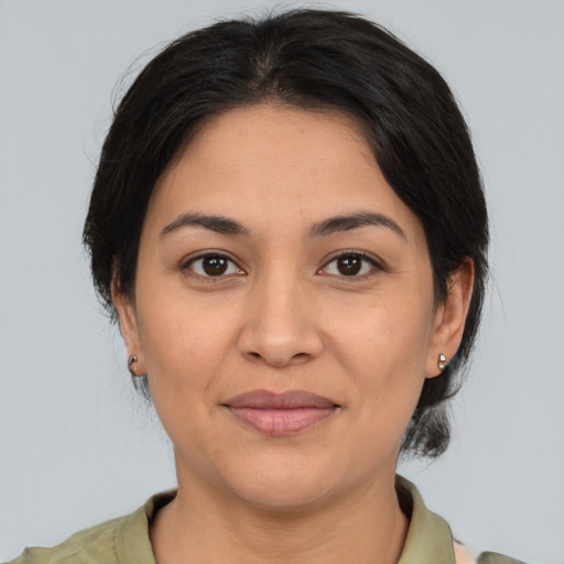 Joyful asian young-adult female with medium  brown hair and brown eyes