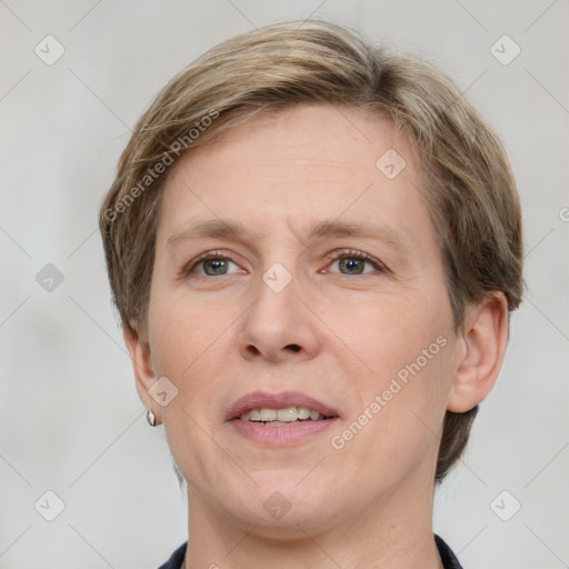 Joyful white adult female with short  brown hair and grey eyes