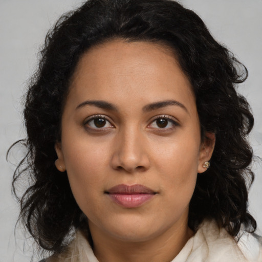 Joyful latino young-adult female with long  brown hair and brown eyes