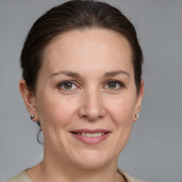 Joyful white adult female with medium  brown hair and grey eyes