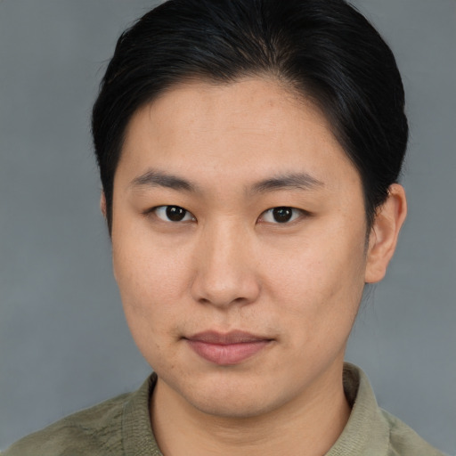 Joyful asian young-adult male with short  brown hair and brown eyes