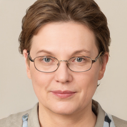 Joyful white adult female with short  brown hair and blue eyes