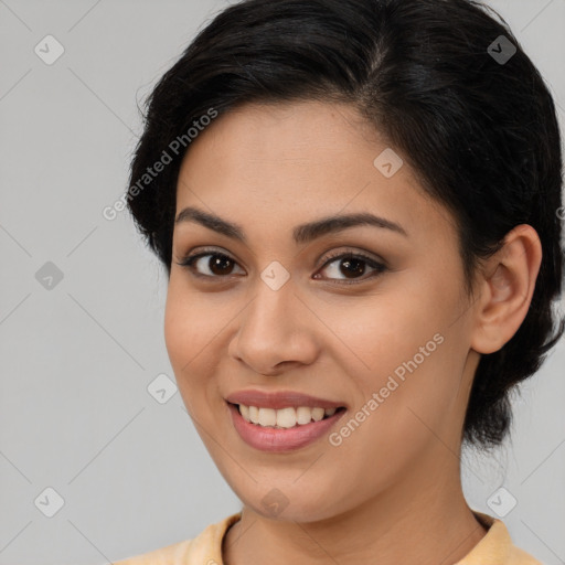 Joyful latino young-adult female with medium  brown hair and brown eyes