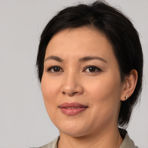 Joyful asian young-adult female with medium  brown hair and brown eyes