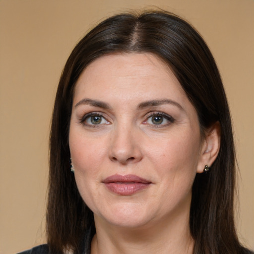 Joyful white adult female with long  brown hair and brown eyes