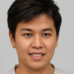 Joyful asian young-adult male with short  brown hair and brown eyes