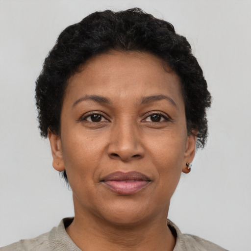 Joyful latino adult female with short  brown hair and brown eyes