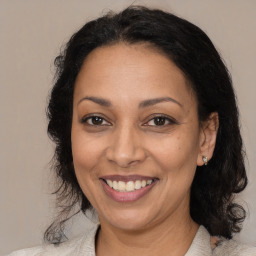 Joyful latino adult female with medium  brown hair and brown eyes