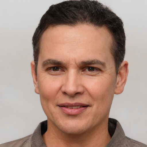 Joyful white adult male with short  brown hair and brown eyes