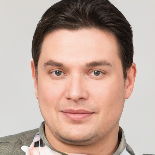 Joyful white young-adult male with short  brown hair and grey eyes